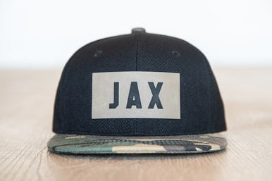 JAX (Leather Custom Name Patch) - Kids Trucker Hat (Black/Camo)