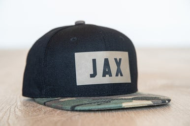JAX (Leather Custom Name Patch) - Kids Trucker Hat (Black/Camo)