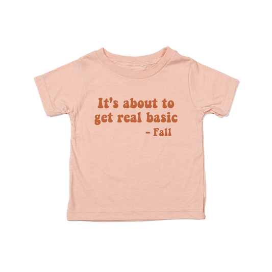 It's about to get real basic (Rust) - Kids Tee (Peach)